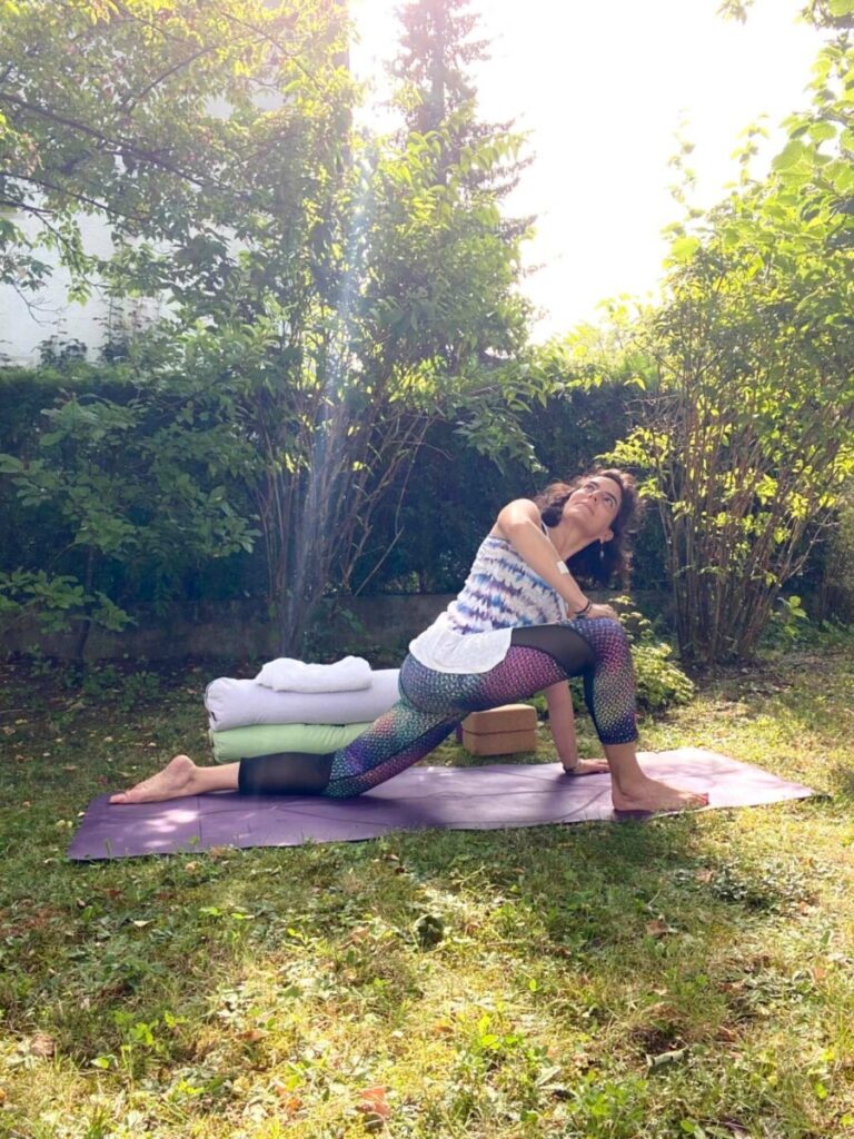 Elif doing yoga in a park